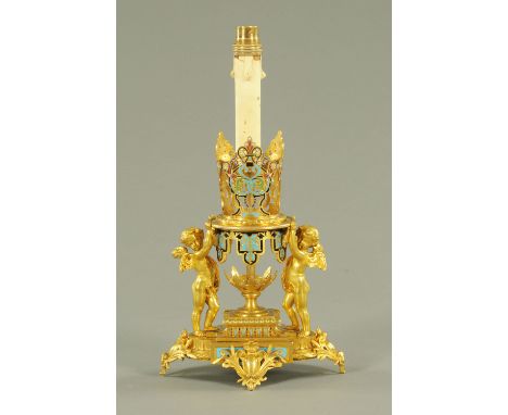 A French gilded metal and champleve enamel table light, late 19th century, modelled as a champleve crown held aloft by two wi