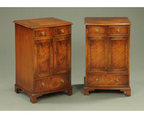 A pair of Regency style mahogany cabinets, with hinged tops and fronts modelled as a pair of cupboard doors with drawer benea