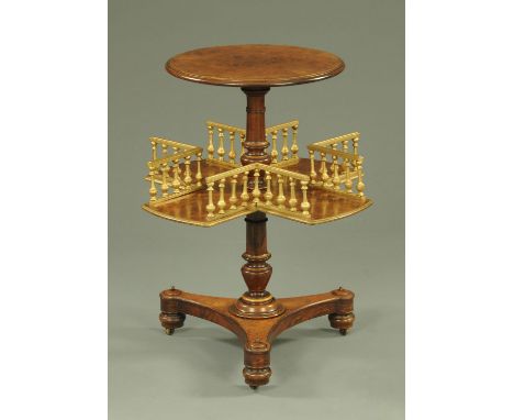 A William IV walnut revolving book table, with circular top and spindle gallery to the lower tier.  Height 70 cm, diameter of