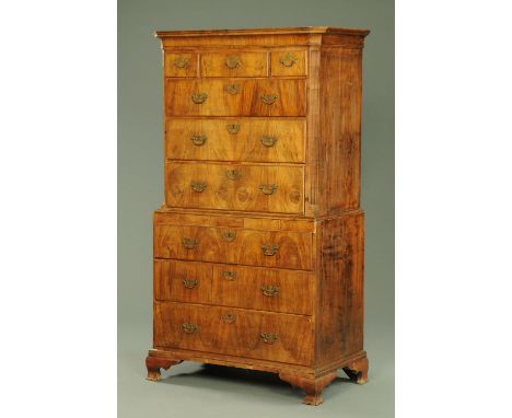 An 18th century walnut tallboy, with moulded cornice above three short and three long drawers with brass drop handles with pi