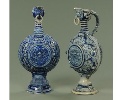 A near pair of large impressive Westerwald moon flask flagons, 19th century, decorated in relief throughout with a variety of