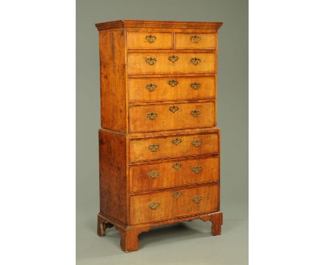 A George III mahogany chest on chest, with moulded cornice above two short and three long graduated drawers with brass drop h