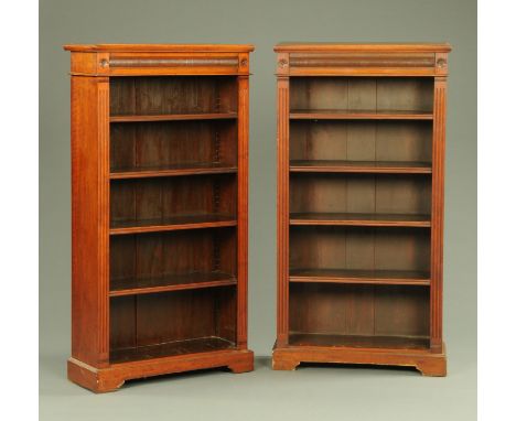 A pair of Edwardian walnut open bookcases, each with moulded edge above a partially turned frieze and with adjustable shelves