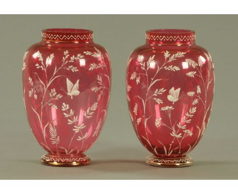 A pair of Victorian cranberry glass vases, decorated with stems and butterflies.  Height 18 cm.  CONDITION REPORT: The gildin