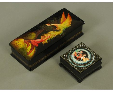 Two Russian lacquered hinged boxes, largest depicting a phoenix, length 16 cm.   CONDITION REPORT: The large box is generally