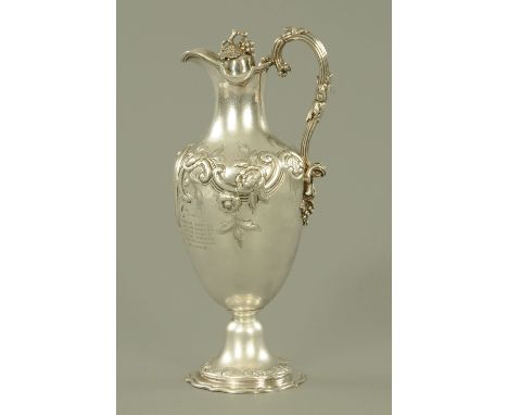 A Victorian silver claret jug, Goldsmiths Alliance Ltd., London 1869, the hinged lid with fruiting vine knop and with scroll 