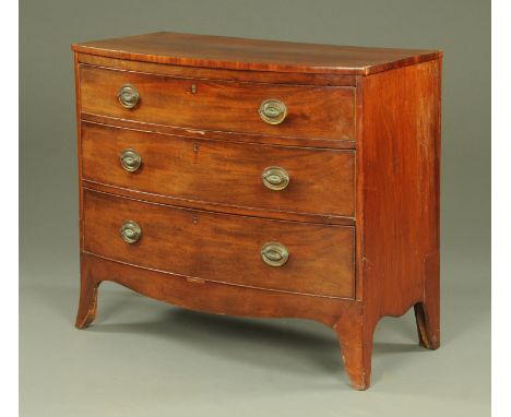 A George III mahogany bowfront chest of drawers, having a well figured top above three long oak lined and cockbeaded drawers,