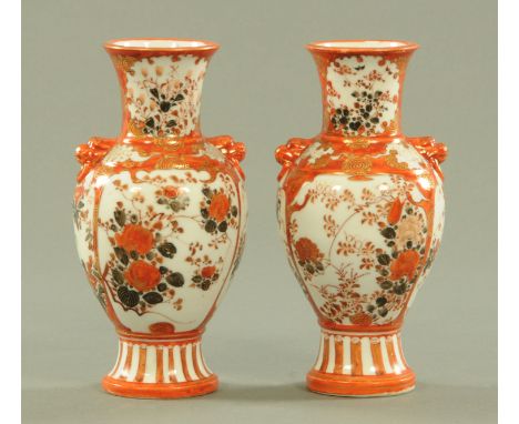 A pair of Japanese Kutani porcelain vases, early 20th century, with lion mask and ring handles and with panels of blossoming 