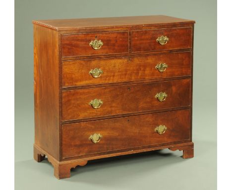 A Georgian mahogany chest of drawers, two short and three long drawers with brass drop handles with shaped backplates and bra