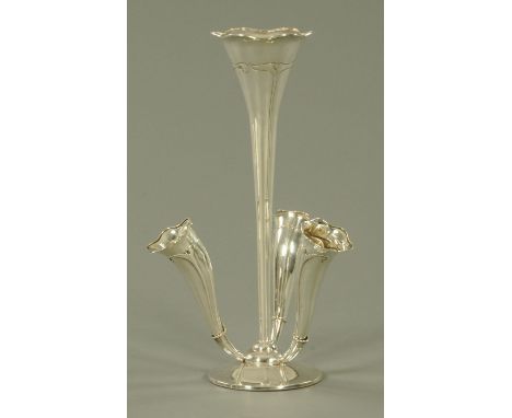 An Edwardian silver four flute epergne, makers marks rubbed, Birmingham 1909, with central trumpet shaped flute flanked by th