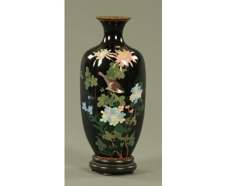 A Japanese cloisonne hexagonal vase, Meiji period, decorated with a bird amongst blossoming chrysanthemums and flowers agains