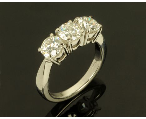 A platinum set three stone diamond ring, round cut and claw set, +/- 2 carats, size M (see illustration).  CONDITION REPORT: 