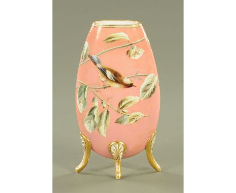 A Victorian Harrach glass and enamel vase, decorated with a bird amongst leafy branches against a salmon pink ground supporte