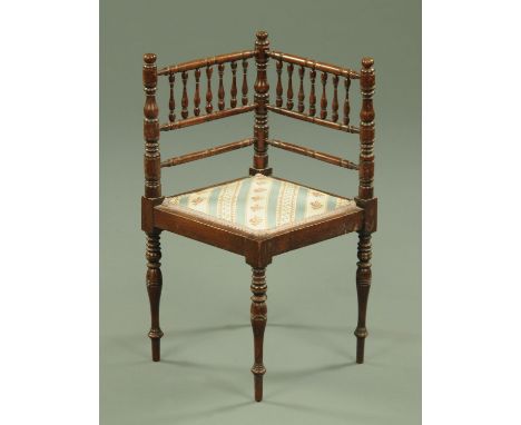 A late Victorian/Edwardian child's bobbin turned corner chair, bearing plaque Bennett Brothers Liverpool.