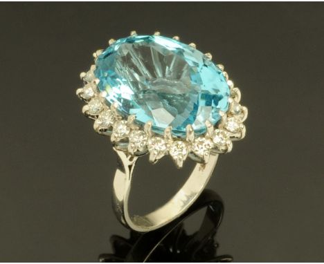 An 18 ct white gold blue topaz cluster ring, topaz +/- 29.71 carats, size M/N.