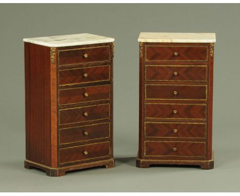 A pair of French miniature semainiers, early 20th century, each with a marble top above six short drawers with gilt metal mou