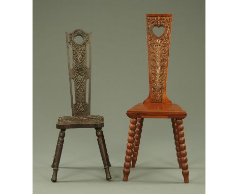 An Arts and Crafts carved walnut spinners chair, the tapering back with pierced heart shaped motif above carved foliage and s