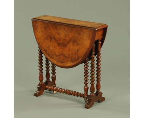 A Victorian walnut Sutherland table, of small proportions, raised on bobbin turned legs with white ceramic castors.  Width wi