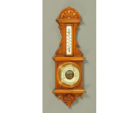 A late Victorian carved oak barometer, with milk glass thermometer, 65 cm. CONDITION REPORT: The bookcase is in structurally 