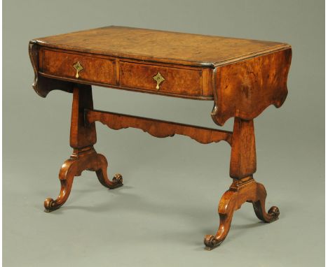 A 19th century walnut veneered sofa table, with crossbanded edge with shaped drop leaves, with two oak lined drawers each wit