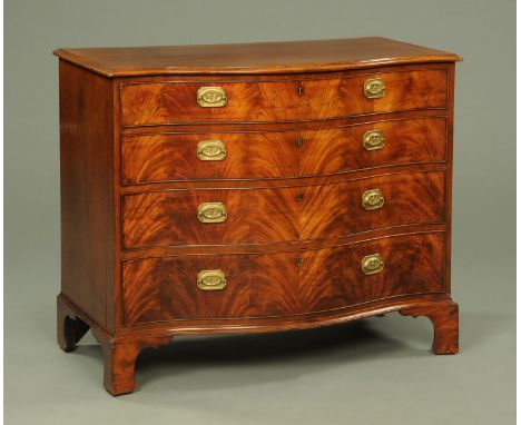 An early 19th century mahogany serpentine fronted chest of drawers, with moulded edge above four long graduated drawers with 