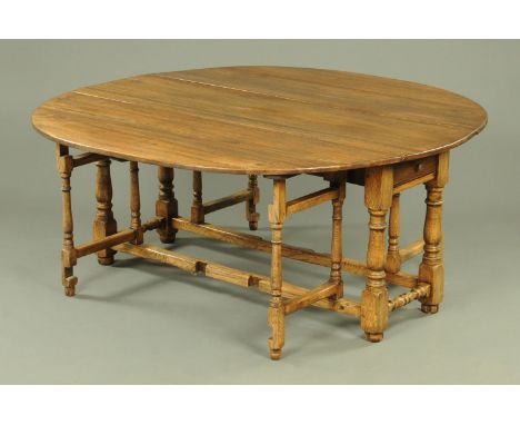 An oak double gate legged dining table.  176 cm x 174 cm open.