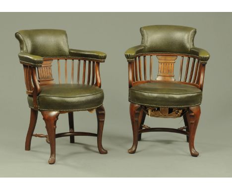 A pair of early 20th century Classical Revival office chairs, each with upholstered back rest and arms, with slatted supports