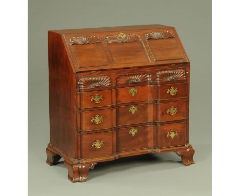 A Georgian mahogany American fall front bureau, with fitted interior with well and with three long frieze drawers with serpen