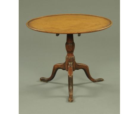 A George III mahogany tripod table, with circular dished top raised on a turned column with three downswept legs.  Diameter 7