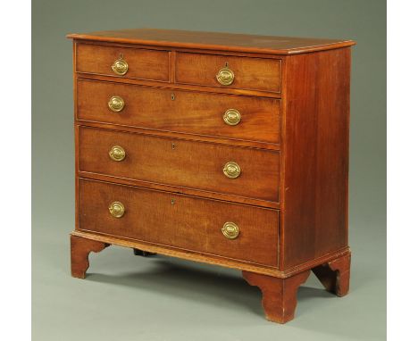 A George III mahogany chest of drawers, with moulded edge above two short and three long graduated drawers with brass drop ha