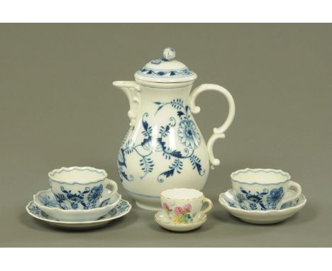 A Meissen onion pattern hot water jug and cover, two cups and saucers and side plate, a small cabinet cup and dish, the teacu