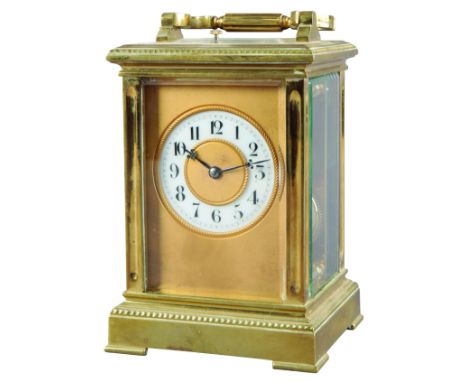 A FRENCH BRASS REPEATING CARRIAGE CLOCK late 19th century, striking on a gong, the enamel dial with Arabic numerals and blue 