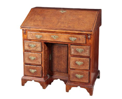 A GEORGE I BURR WALNUT KNEEHOLE BUREAUthe fall front opening to reveal a gilt tooled leather writing surface with a fitted in