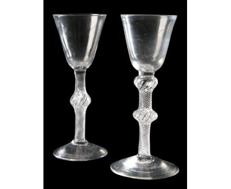 AN 'AIR TWIST' WINE GLASS mid 18th century, the round funnel over a subtle shoulder inverted baluster and annular knopped air