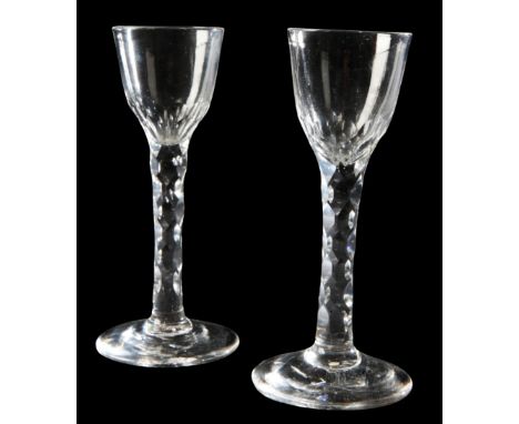 A PAIR OF FACET-CUT WINE GLASSES late 18th century, the pointed round funnel with basal fluting over facet-cut stem, 16cm hig