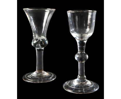 TWO GEORGIAN WINE GLASSES early/mid-18th century, with folded feet, one with teared shoulder knop, the tallest measuring 14cm