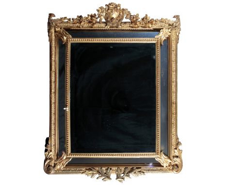A GILTWOOD AND COMPOSITION MARGINAL CUSHION MIRROR20th century, the rectangular bevelled plate within four further conforming