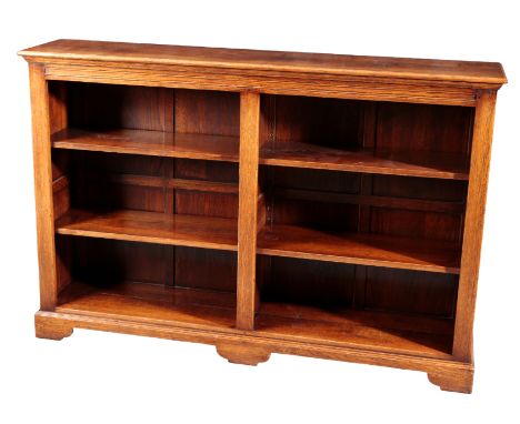 AN OAK OPEN BOOKCASE20th century, the moulded rectangular top over two banks of three adjustable shelves, on shaped bracket f