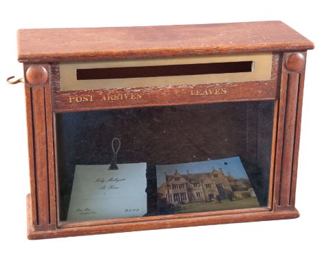 AN ENGLISH OAK LETTER BOX 19th/20th century, the glazed front panel with a brass letter slot over gilt text 'Post Arrives ...
