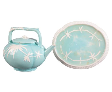 A WEDGWOOD POTTERY TEAPOT OF AESTHETIC DESIGN late 19th century, the bulbous oval body with raised bamboo flowers in white on