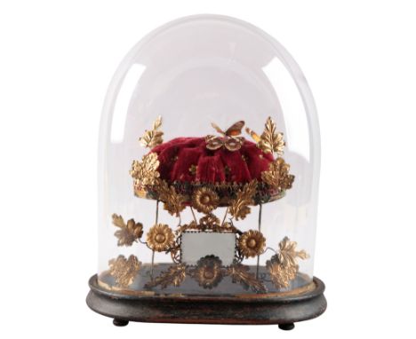 A 'GLOBE DE MARIÉE' 19th century, with three butterflies pinned to a plush red cushion, encircled by gilt flowers and foliage