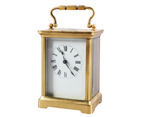 A FRENCH BRASS CARRIAGE CLOCK19th century, the white enamel dial with Roman numerals, bevelled glass side panels, 16cm high x