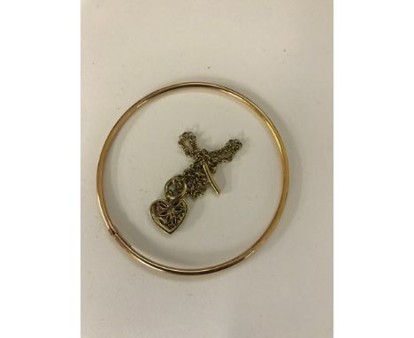 A 9ct bangle and 9ct T-bar bracelet with ruby set pendant