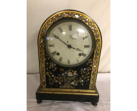 An early 20th century mother-of-pearl inlaid arch-shaped mantel clock