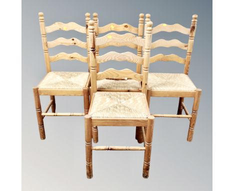 A set of four pine rush seated ladder backed chairs 