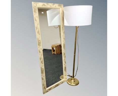 A contemporary gilt hall mirror and brass standard lamp with shade 