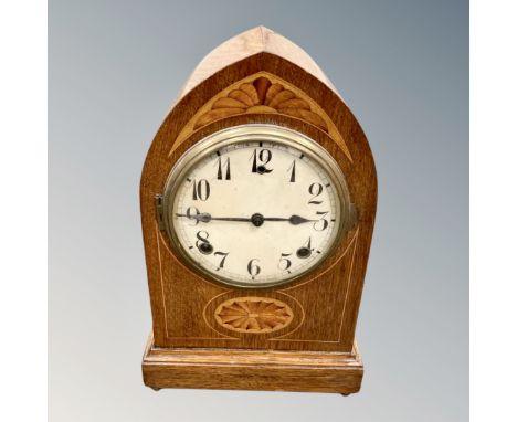 An Edwardian inlaid oak mantel clock with pendulum 