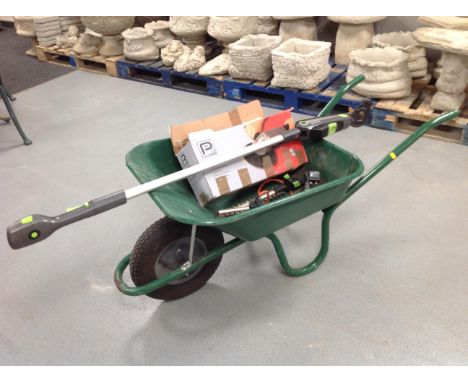 A wheel barrow containing performance angle grinder, boxed, G-tech garden multi tool with interchangeable heads and heat gun 