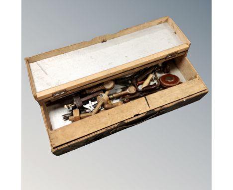 A joiner's tool box containing hand tools, leather tape measure etc 