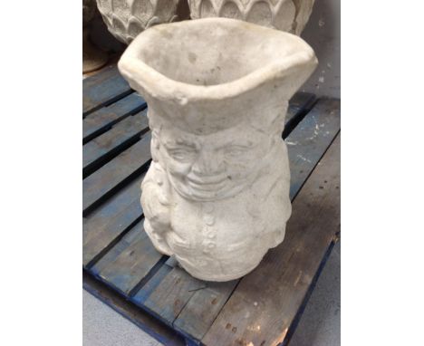 A concrete Toby Jug planter 
